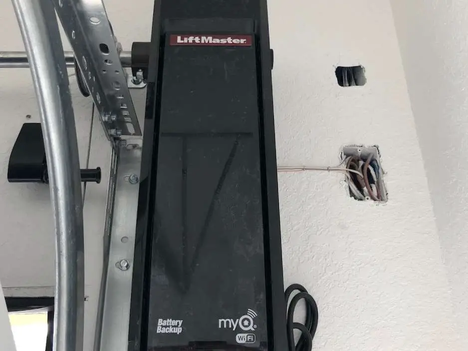 Power outlet and prewire installed to the right of the LiftMaster 8500W jackshaft garage door opener.