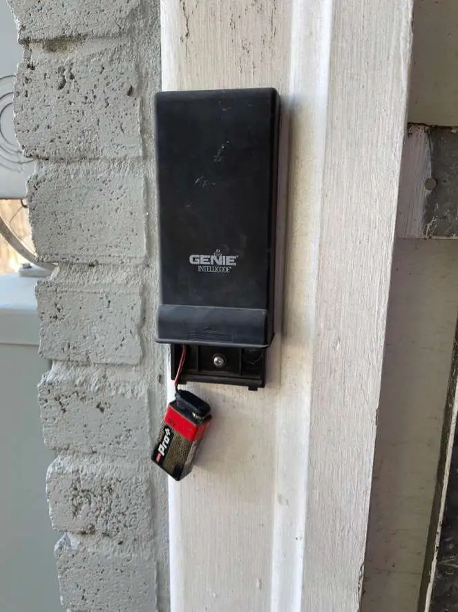 Older Genie outdoor keypad with slide up cover.