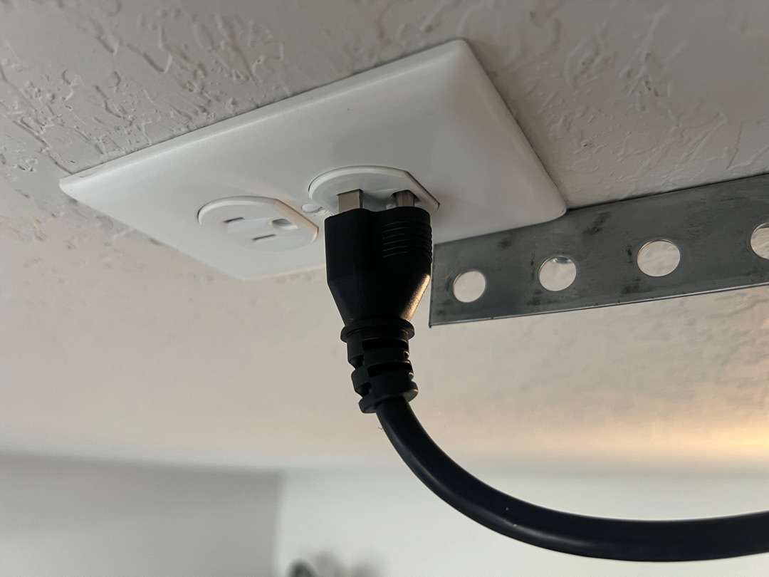 Opener cord not fully plugged into ceiling outlet.